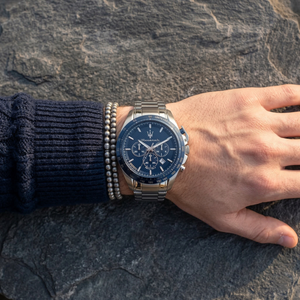 Close up of Maserati Traguardo R8873612043 men's quartz battery watch on wrist showing blue chronograph dial and silver metal bracelet