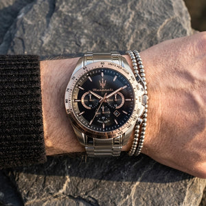 Close up of Maserati Traguardo R8873612047 men's quartz battery watch on wrist showing black chronograph dial and silver metal bracelet