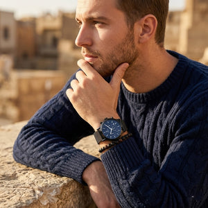 Elegant man wearing Maserati Epoca R8873618008 men's quartz battery watch with black case and luxury blue dial