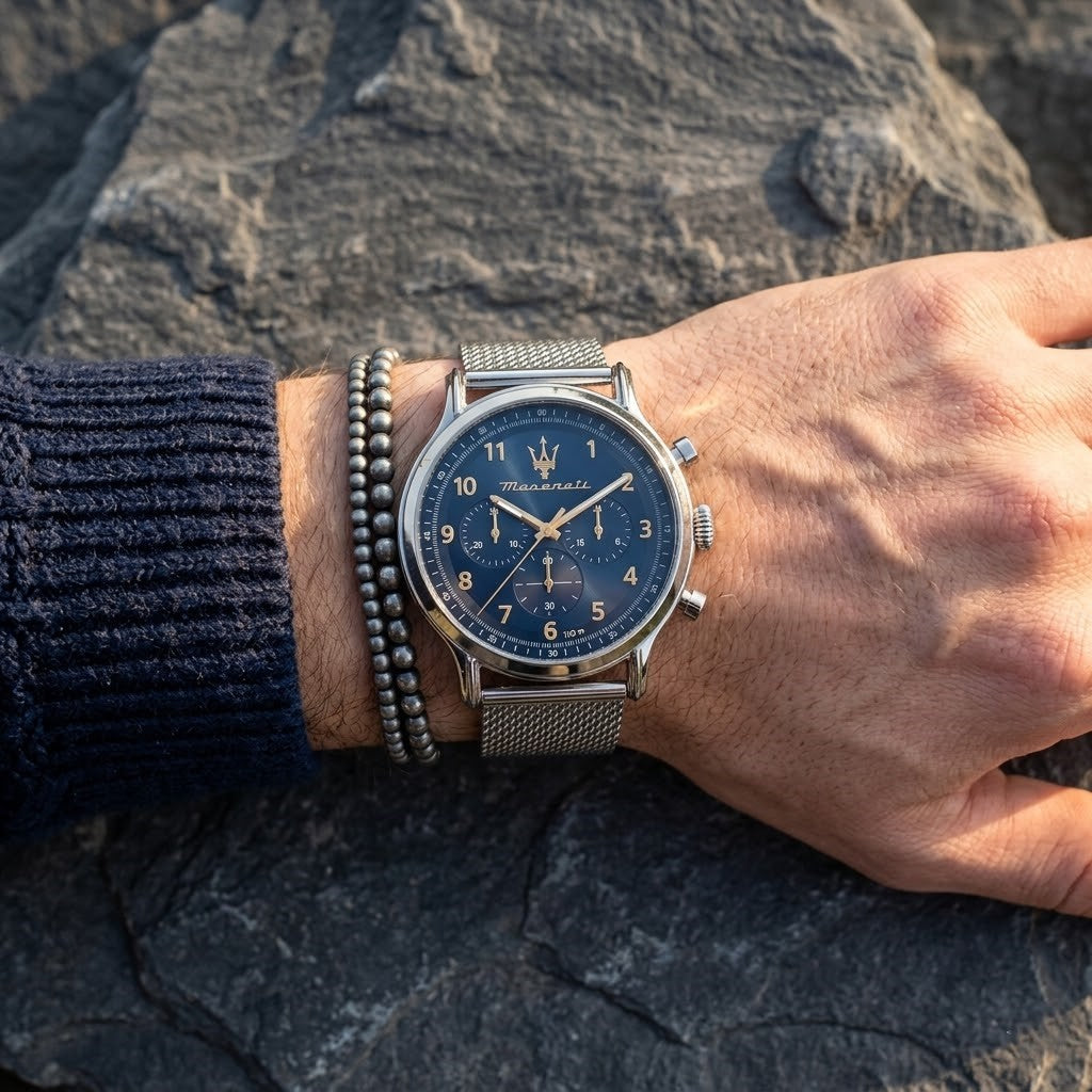 Close up of Maserati Epoca R8873618022 men's quartz battery watch on wrist showing blue sunray dial and silver mesh metal strap