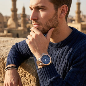 Elegant man wearing Maserati Ingegno R8873619002 men's quartz battery watch with two-tone case and multi-layered blue dial
