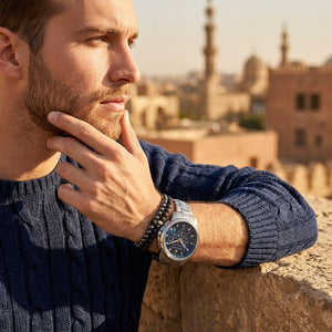Elegant man wearing Maserati Successo R8873621002 men's quartz battery watch with silver-tone case and luxury blue dial