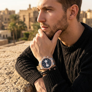 Elegant man wearing Maserati Circuito R8873627004 men's quartz battery watch with two-tone rose gold case and luxury black dial