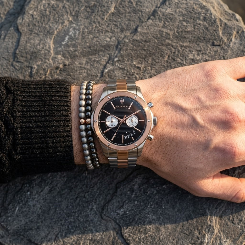 Close up of Maserati Circuito R8873627004 men's quartz battery watch on wrist showing black textured dial and two-tone rose gold metal bracelet