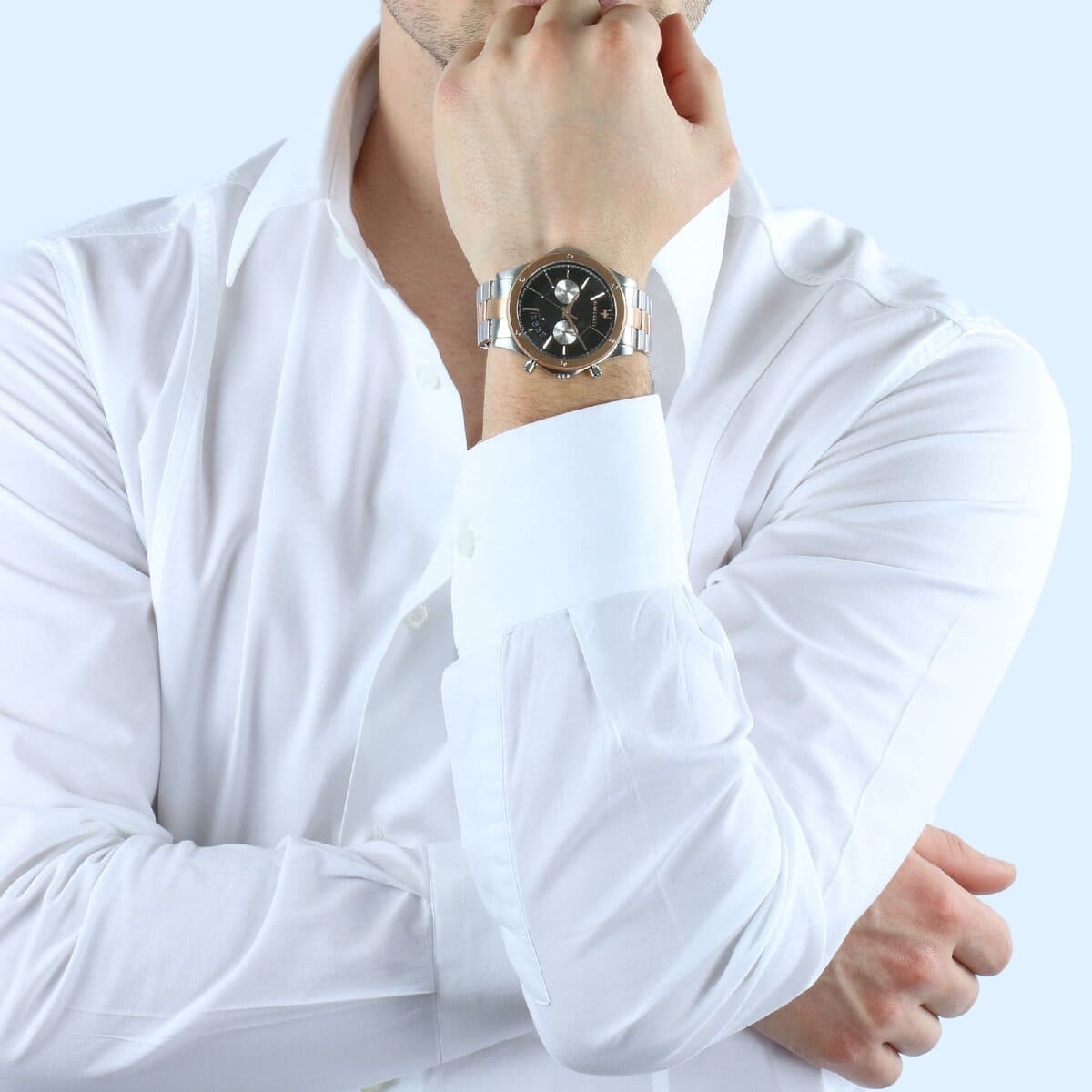 Elegant man wearing Maserati Circuito R8873627004 men's quartz battery watch with two-tone rose gold case and luxury black dial