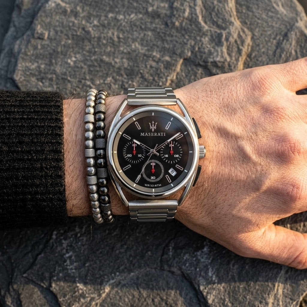 Close up of Maserati Trimarano R8873632003 men's quartz battery watch on wrist showing black racing dial and silver metal bracelet