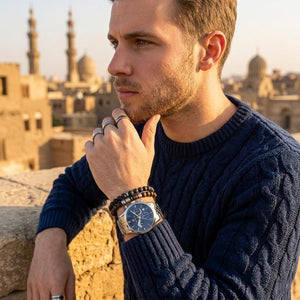 Elegant man wearing Maserati Ricordo R8873633001 men's quartz battery watch with silver-tone case and luxury blue dial