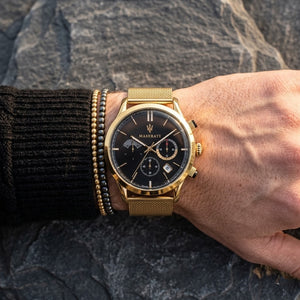 Close up of Maserati Ricordo R8873633003 men's quartz battery watch on wrist showing black sunray dial and gold mesh metal strap
