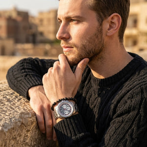 Elegant man wearing Maserati Royale R8873637003 men's quartz battery watch with silver case and luxury gray striped dial