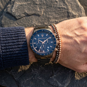 Close up of Maserati Sfida R8873640001 men's quartz battery watch on wrist showing blue sunray dial and gunmetal gray metal bracelet