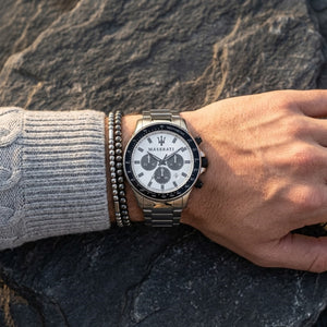 Close up of Maserati Sfida R8873640003 men's quartz battery watch on wrist showing white panda chronograph dial and silver metal bracelet