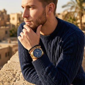 Elegant man wearing Maserati Sfida R8873640008 men's quartz battery watch with gold case and luxury blue dial