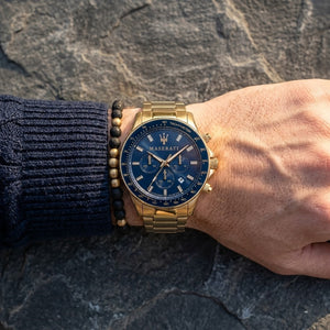 Close up of Maserati Sfida R8873640008 men's quartz battery watch on wrist showing blue racing dial and luxury gold case