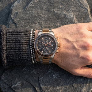 Close up of Maserati Sfida R8873640014 men's quartz battery watch on wrist showing grey chronograph dial and two-tone metal bracelet
