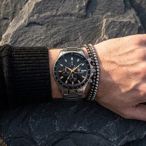 Close up of Maserati Sfida R8873640015 men's quartz battery watch on wrist showing black chronograph dial and silver metal bracelet