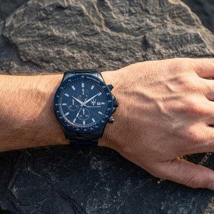 Close up of Maserati Sfida R8873640023 men's quartz battery watch on wrist showing blue chronograph dial and blue metal bracelet