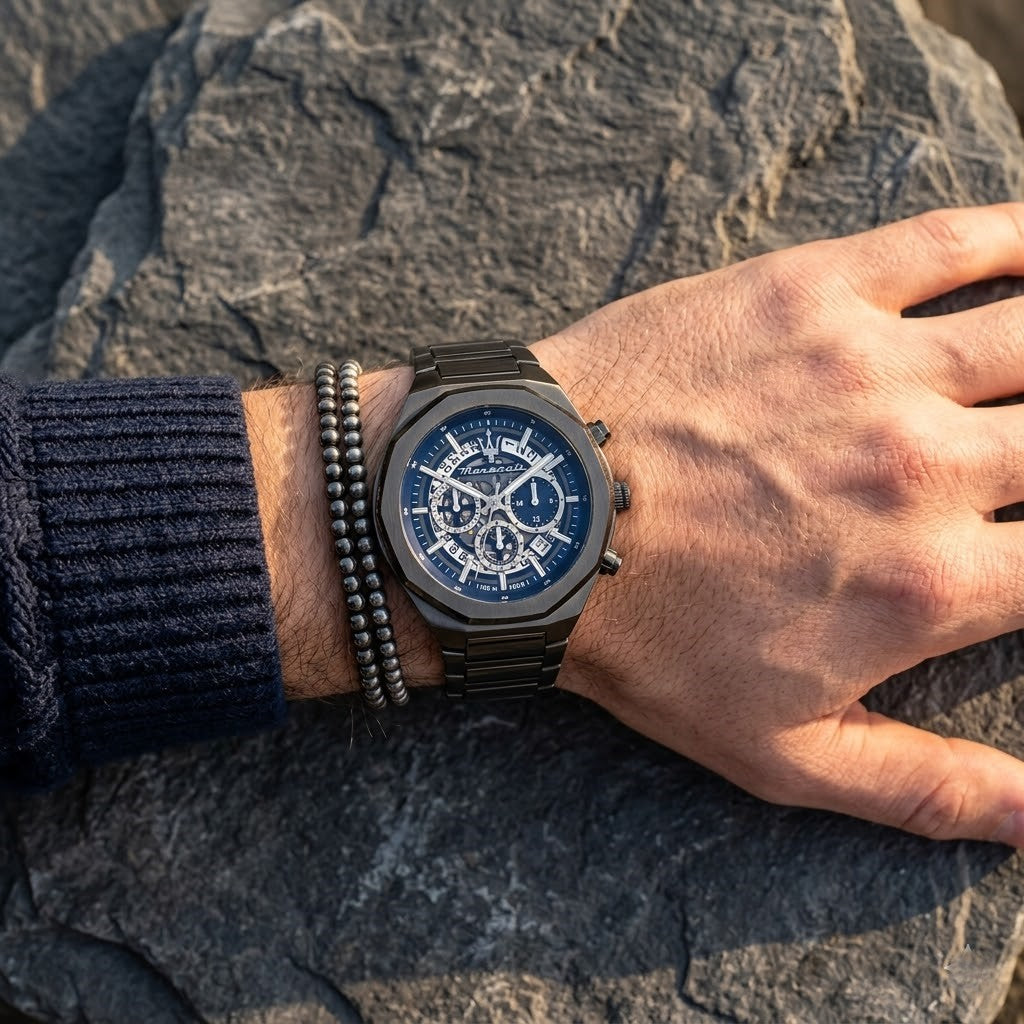 Close up of Maserati Stile R8873642012 men's quartz battery watch on wrist showing blue skeleton dial and gunmetal grey metal bracelet