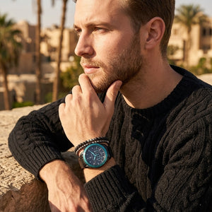 Elegant man wearing Maserati Traguardo Aqua Edition R8873644002 men's quartz battery watch with black case and luxury Tiffany blue accents