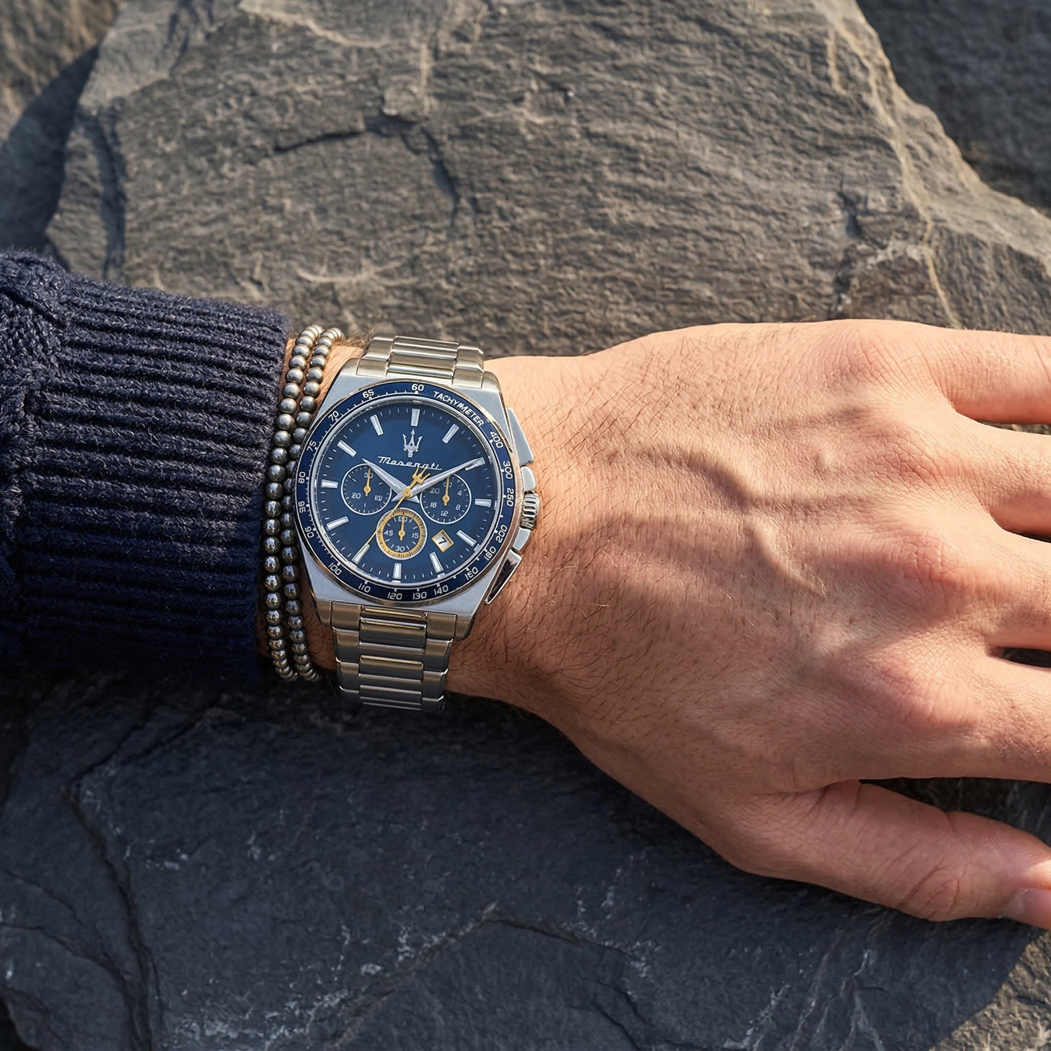 Close up of Maserati Velocita R8873652001 men's quartz battery watch on wrist showing blue racing dial and silver metal bracelet