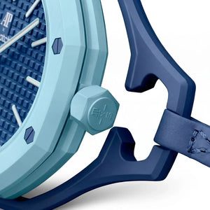 Close-up of a blue watch with a textured face and strap on a white background