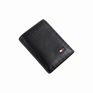 Front studio view of the Tommy Hilfiger black trifold wallet showing the premium grained leather texture and small enamel flag logo