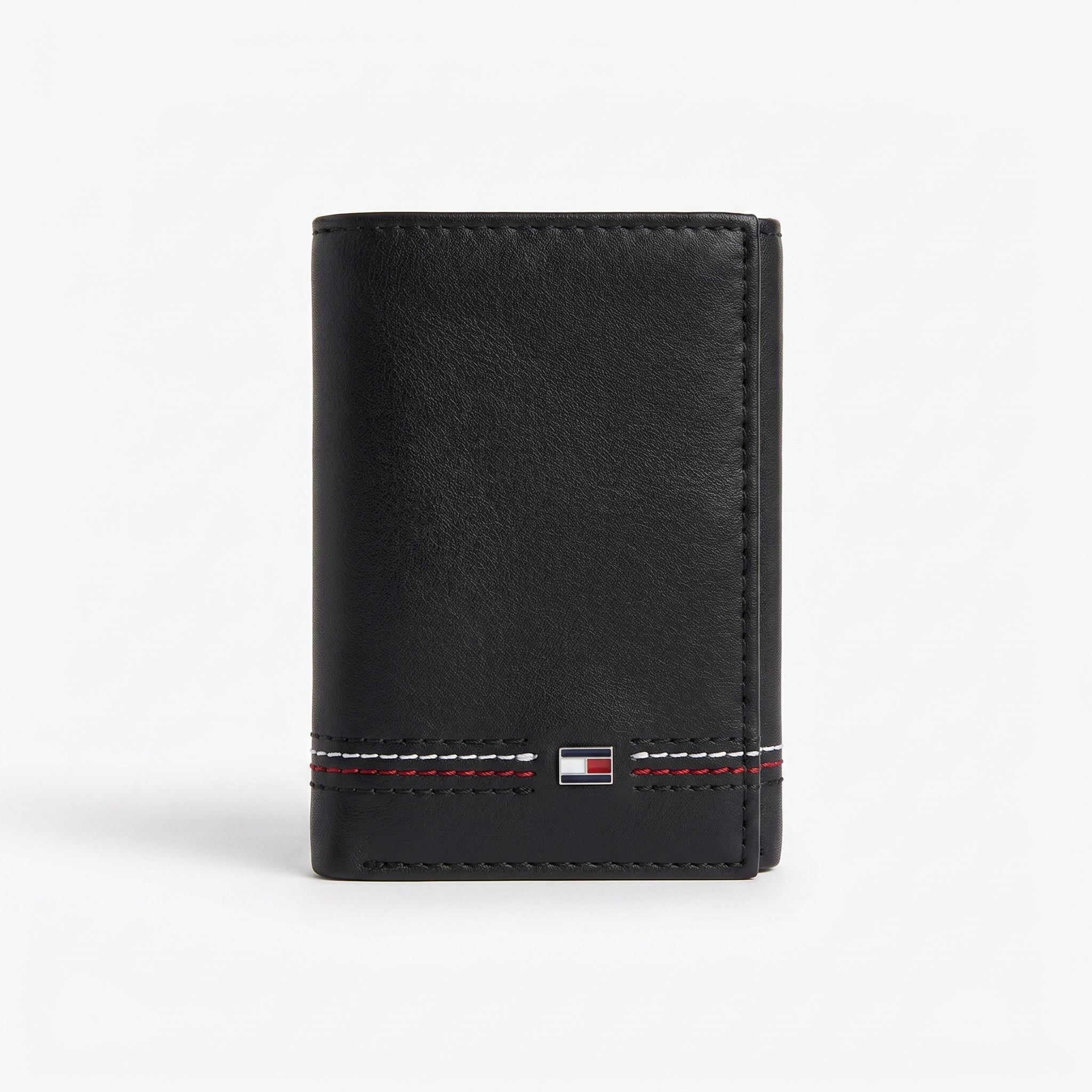 Front studio view of the Tommy Hilfiger black bi-fold wallet showcasing the premium smooth leather surface and corner metal flag logo
