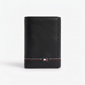 Front studio view of the Tommy Hilfiger black bi-fold wallet showcasing the premium smooth leather surface and corner metal flag logo