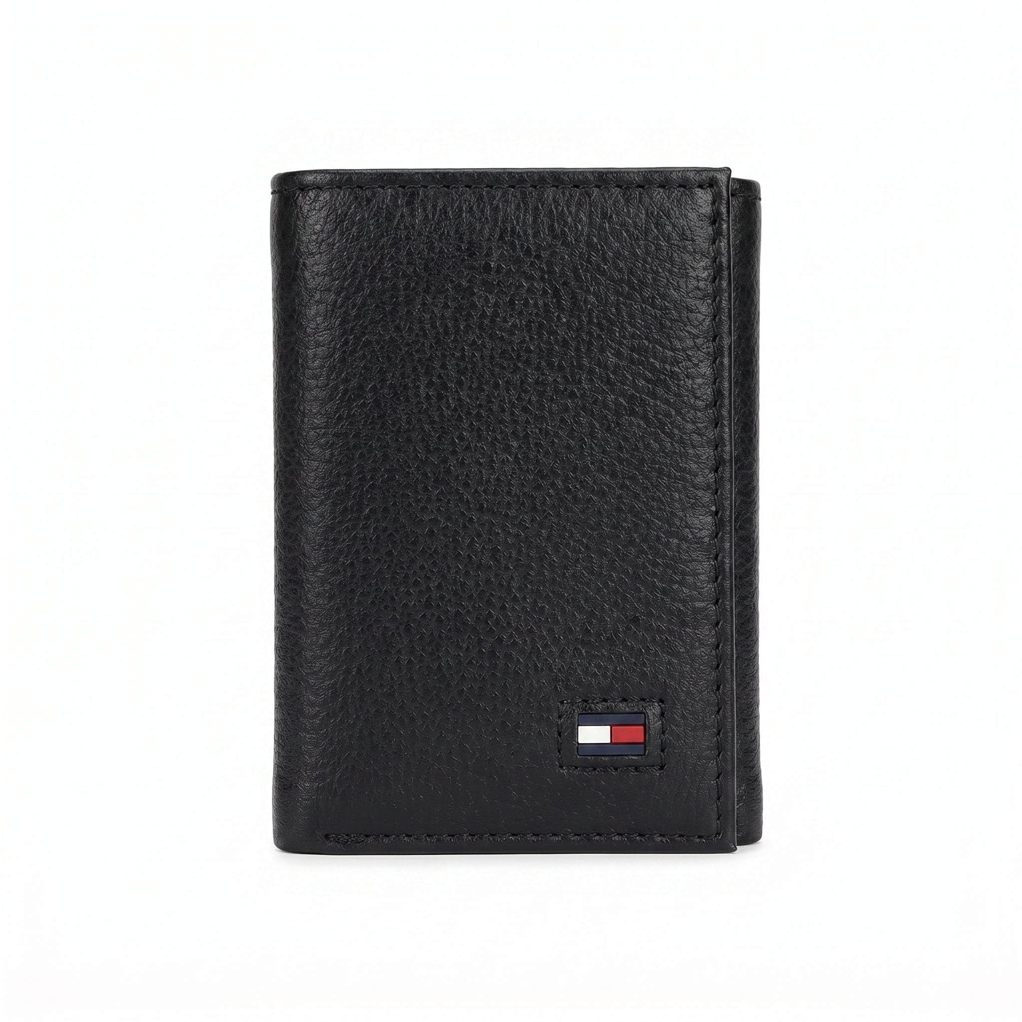 Macro close-up view showing the high-quality grained leather texture and fine stitching around the Tommy Hilfiger flag logo