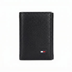 Macro close-up view showing the high-quality grained leather texture and fine stitching around the Tommy Hilfiger flag logo