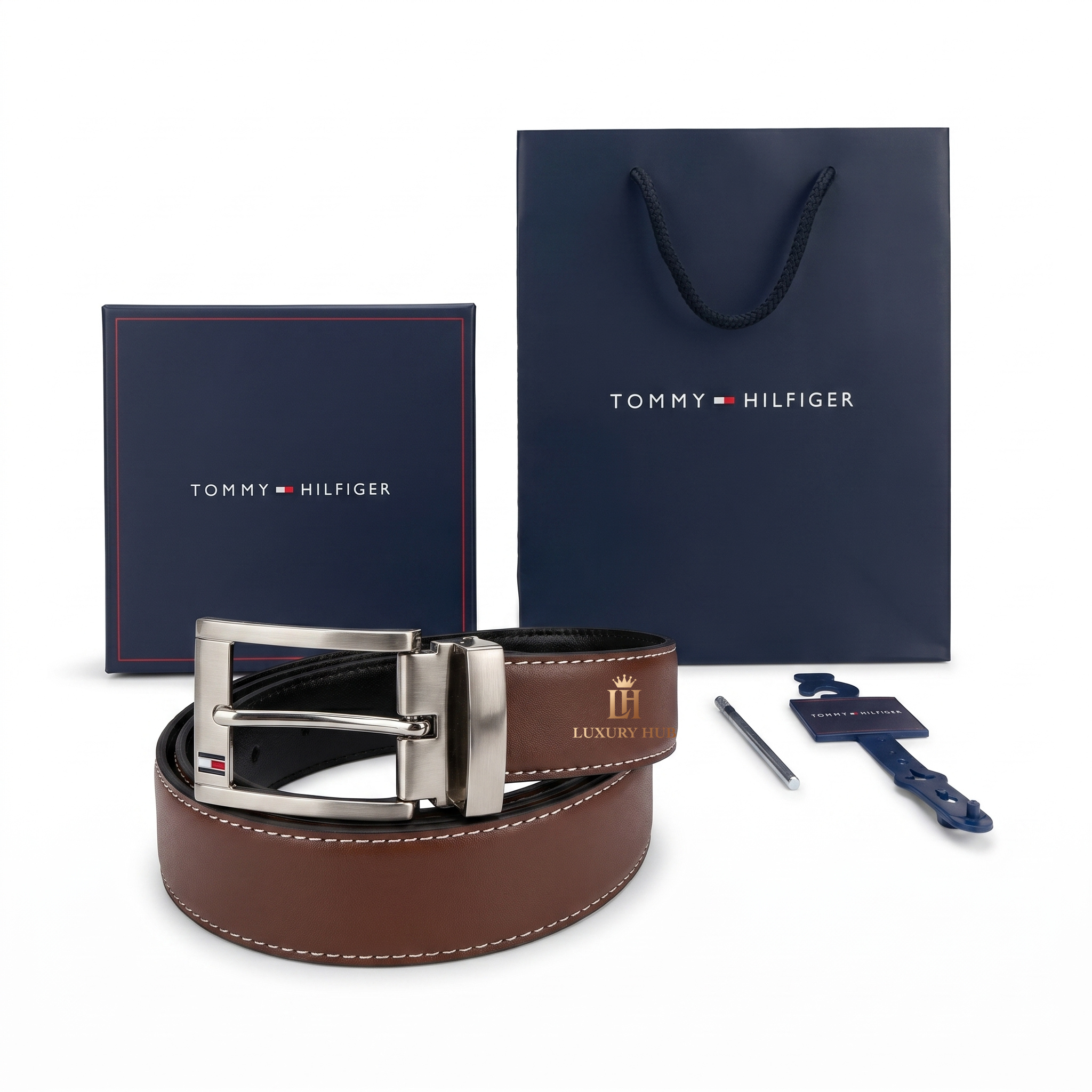 Brown belt with silver buckle and Tommy Hilfiger packaging on a white background
