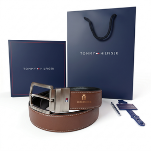 Tommy Hilfiger brown leather belt with silver buckle, packaging box, and shopping bag on a white background.