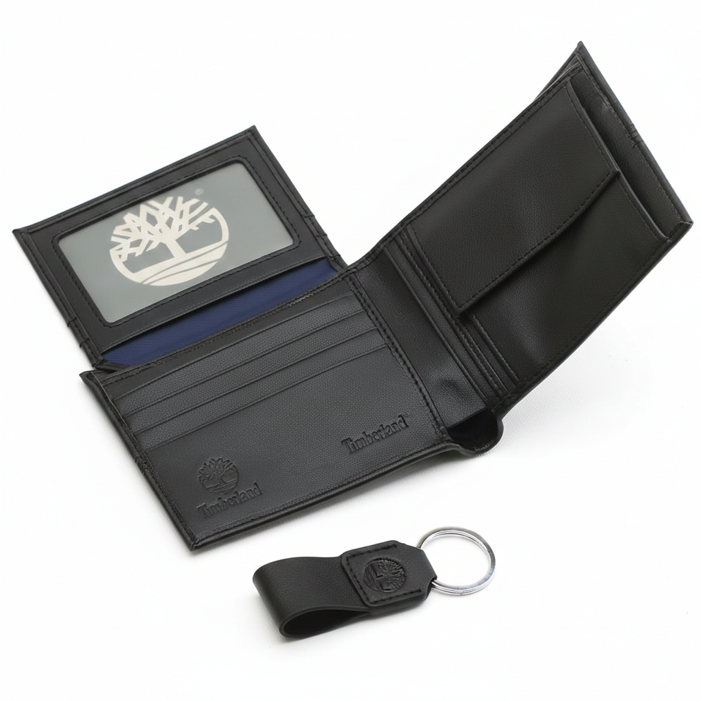 Interior view of an open Timberland black leather wallet showcasing card slots and an ID window with the tree logo, paired with a matching leather keychain