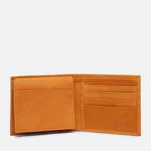 Studio interior view of the opened Timberland smooth wheat tan leather bifold wallet showcasing symmetrical multi-card slots and premium stitched edges
