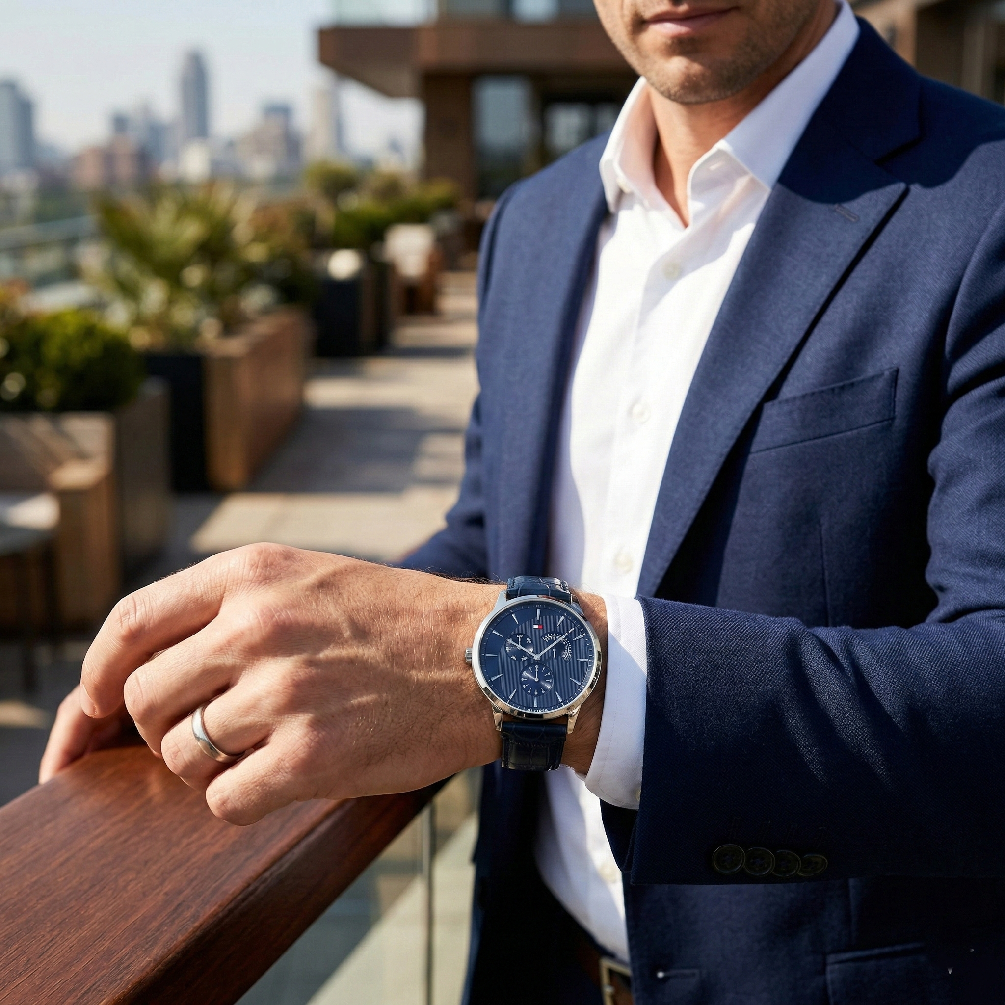 Man wearing Tommy Hilfiger Brad navy blue leather watch for a smart-casual and professional look.