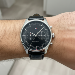 Close up shot of Tommy Hilfiger 1710424 watch on wrist showing the black dual time dial