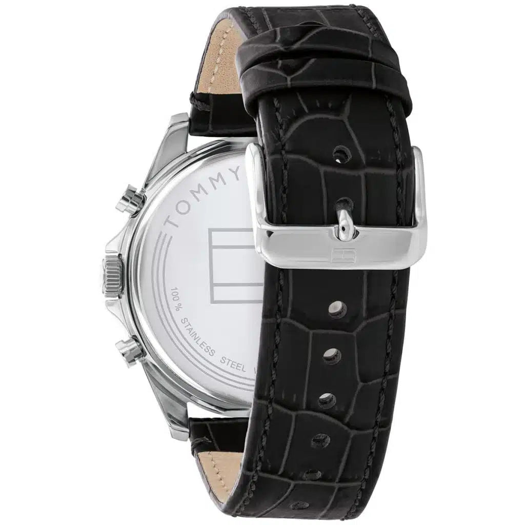 Left side perspective of the silver case and detailed stitching on the black leather strap of the Tommy Hilfiger watch