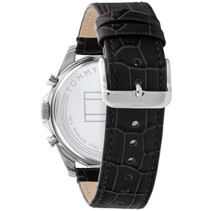 Left side perspective of the silver case and detailed stitching on the black leather strap of the Tommy Hilfiger watch