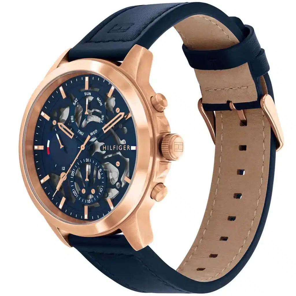 Angled view of the Tommy Hilfiger 1710475 highlighting the rose gold stainless steel case and blue bezel