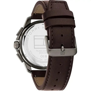 Left side perspective of the gunmetal case and detailed stitching on the brown leather strap of the Tommy Hilfiger watch