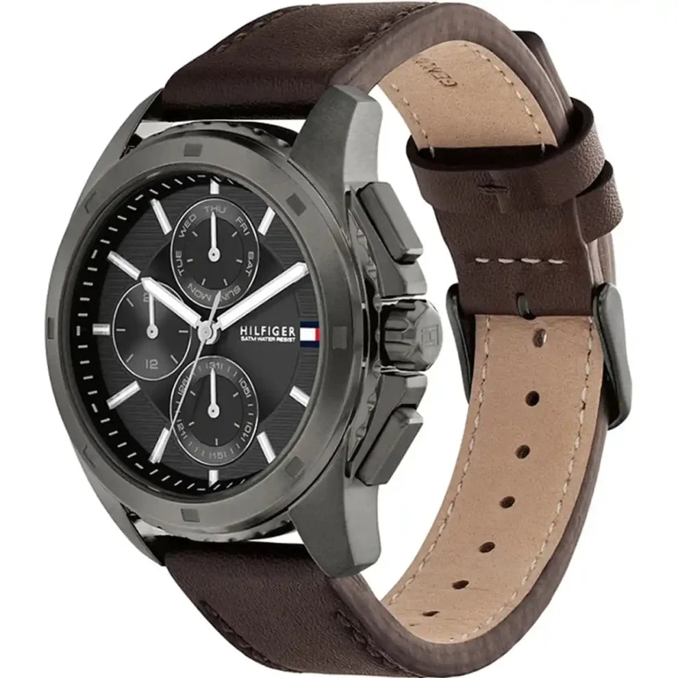 Angled view of Tommy Hilfiger 1710623 highlighting the polished gunmetal case and premium brown leather strap
