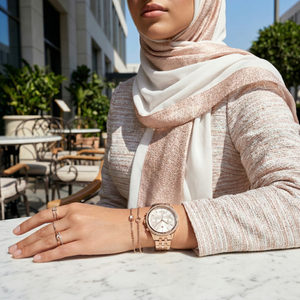 Woman wearing Tommy Hilfiger Ari rose gold-tone watch for a romantic evening and high-end professional look
