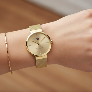 Close up shot of Tommy Hilfiger 1782217 watch on wrist showing the minimalist gold dial