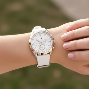 Detailed macro view of the crystal-studded gold bezel and white dial of Tommy Hilfiger 1782388