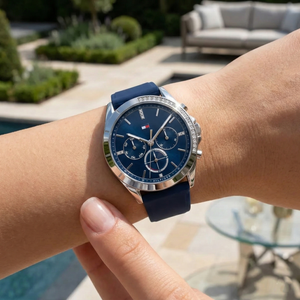 Close up shot of Tommy Hilfiger 1782389 on wrist showing the navy blue dial, crystal details, and day-date sub-dials