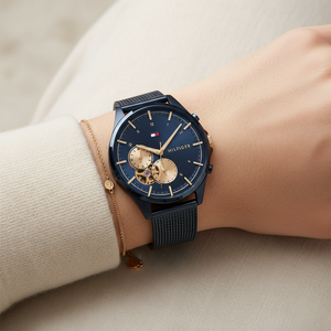 Close up shot of Tommy Hilfiger 1782418 watch on wrist showing the blue skeleton window and rose gold accents
