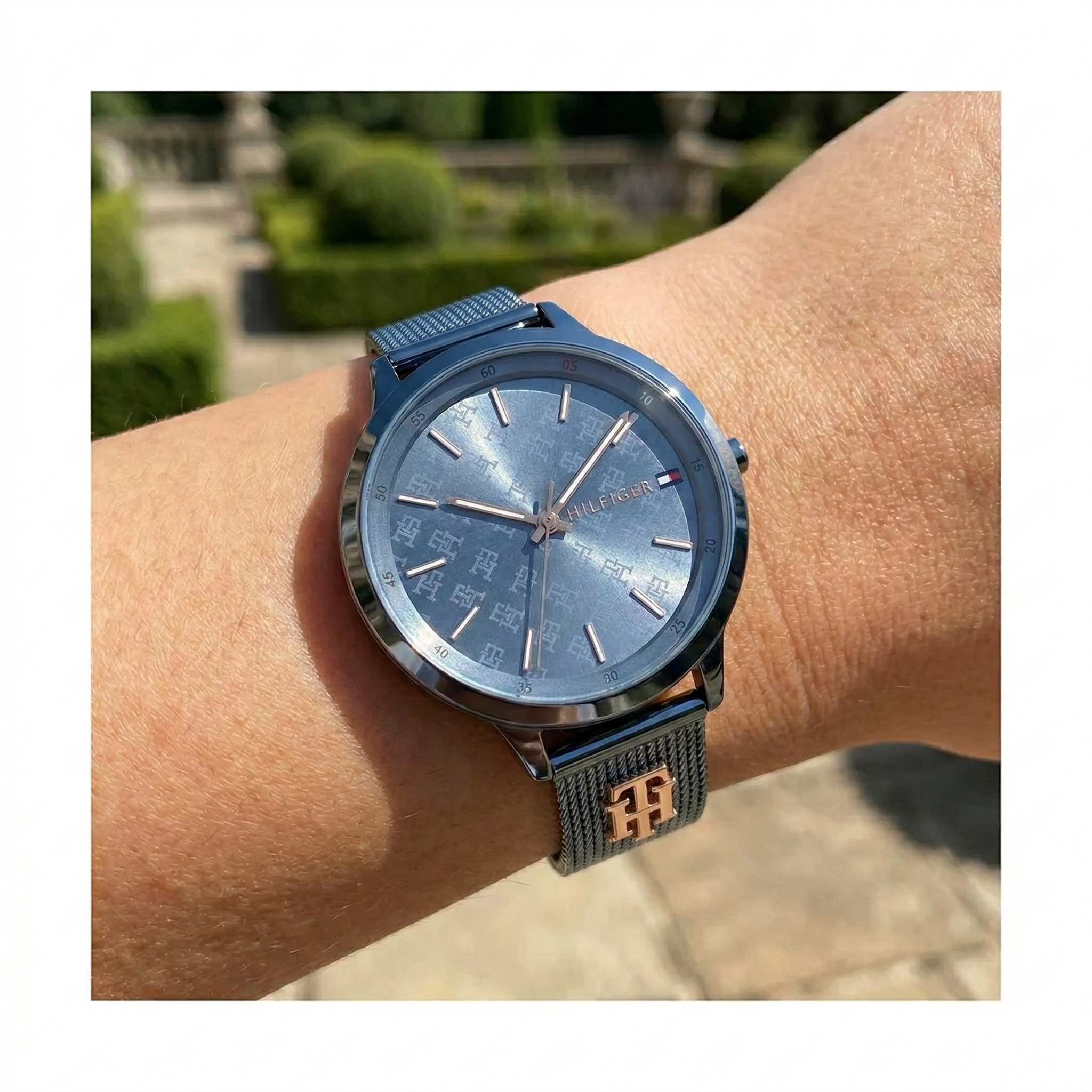 Close up shot of Tommy Hilfiger 1782589 on wrist showing the intricate TH monogram dial pattern and rose gold hands