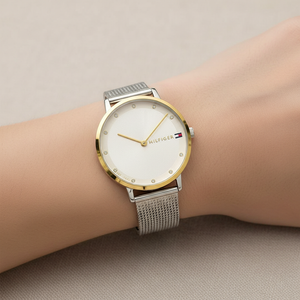 Close up shot of Tommy Hilfiger 1782667 watch on wrist showing the slim silver and gold case
