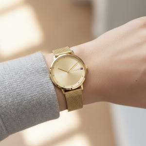 Close up shot of Tommy Hilfiger 1782728 watch on wrist showing the slim case and gold sunray dial