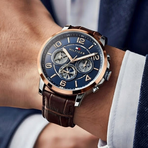 Close up shot of Tommy Hilfiger 1791290 watch on wrist showing the blue skeleton dial details
