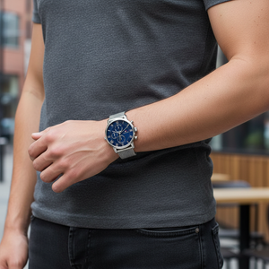Man wearing Tommy Hilfiger Kane silver and blue mesh watch for a sophisticated, classic, and elegant professional look